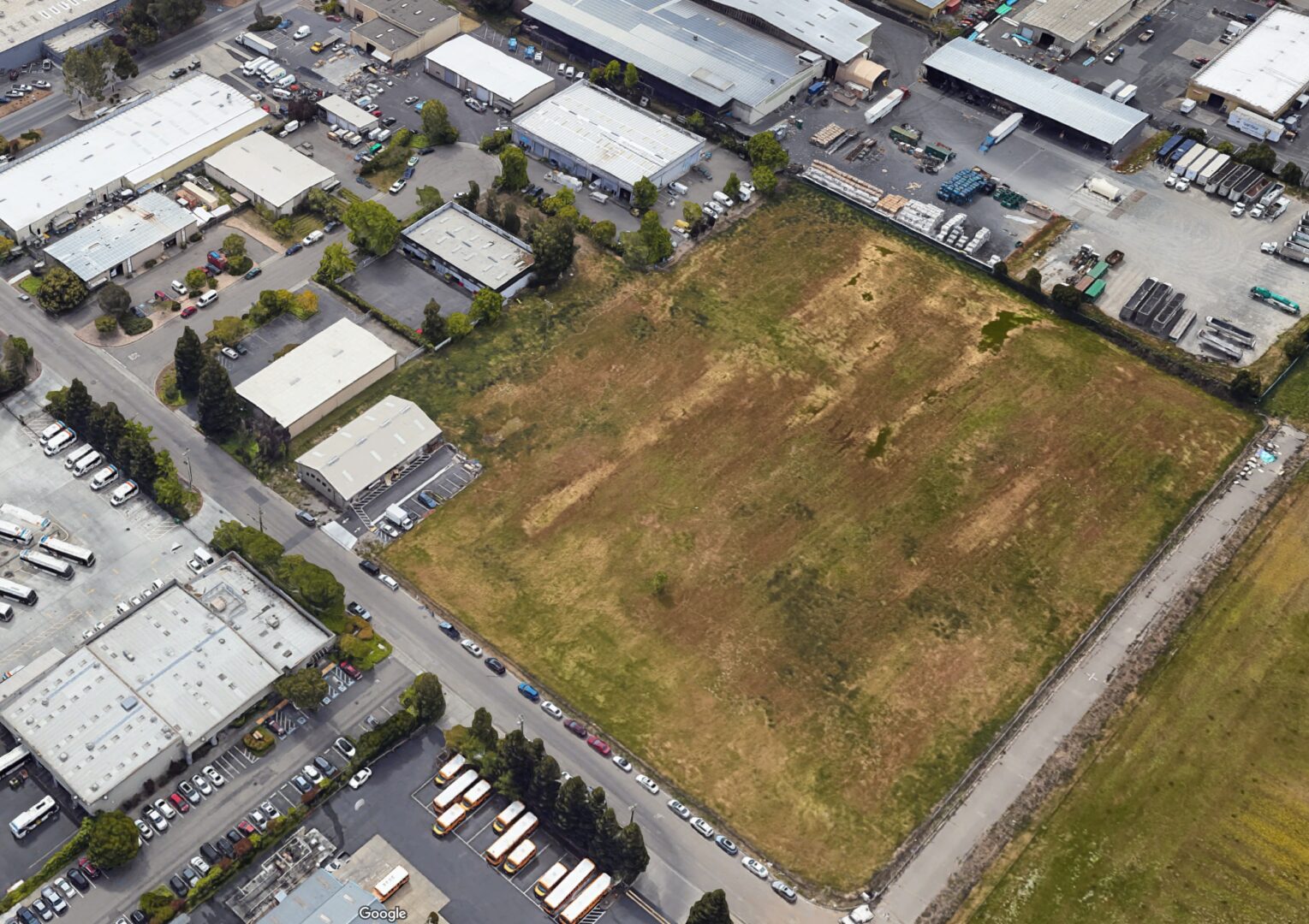 Ariel shot of a plan land surrounded with houses